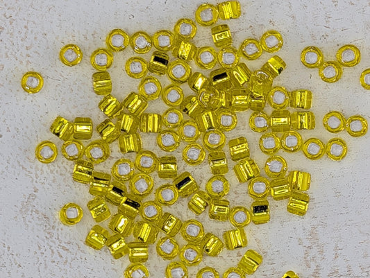 5104SB Silver Lined Translucent Yellow Round With Square Hole 6/0 (15g Pkg)