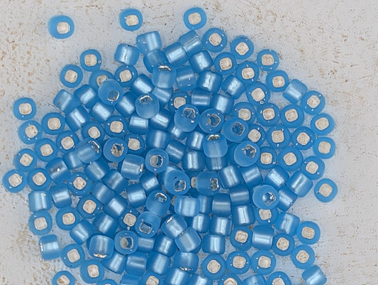 a collection of blue and white beads scattered on a surface.