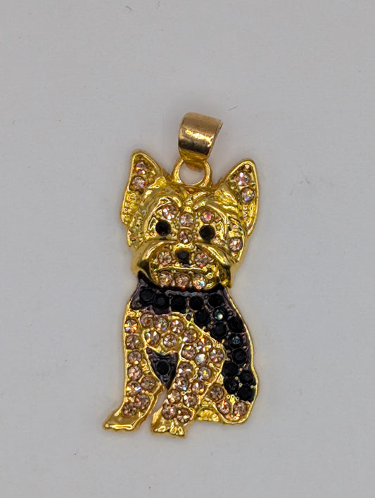 A gold-colored pendant in the shape of a dog, adorned with small diamonds and rhinestones.
