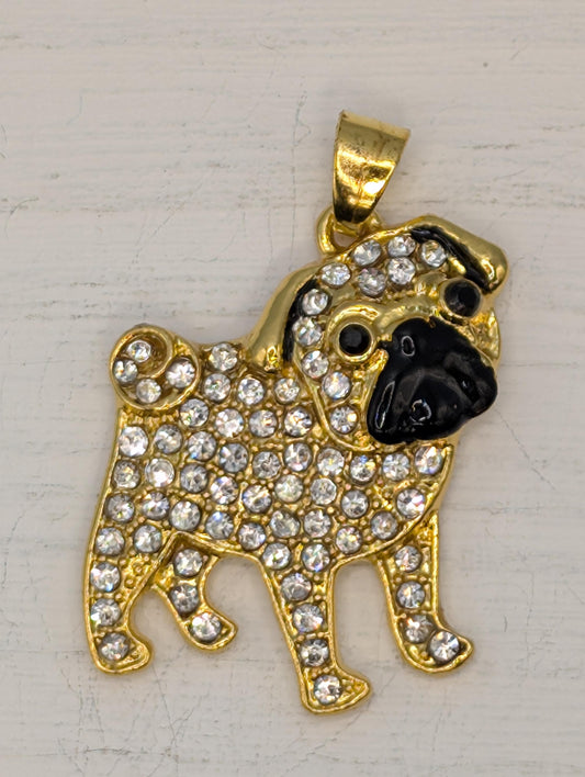 A gold-colored pendant in the shape of a dog, adorned with numerous sparkling diamonds.