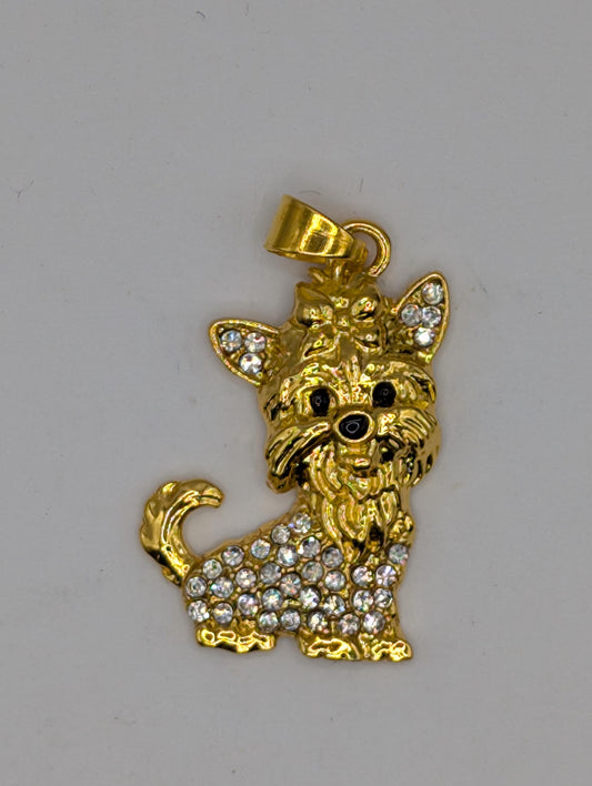 A gold-colored pendant in the shape of a dog, adorned with small diamonds.