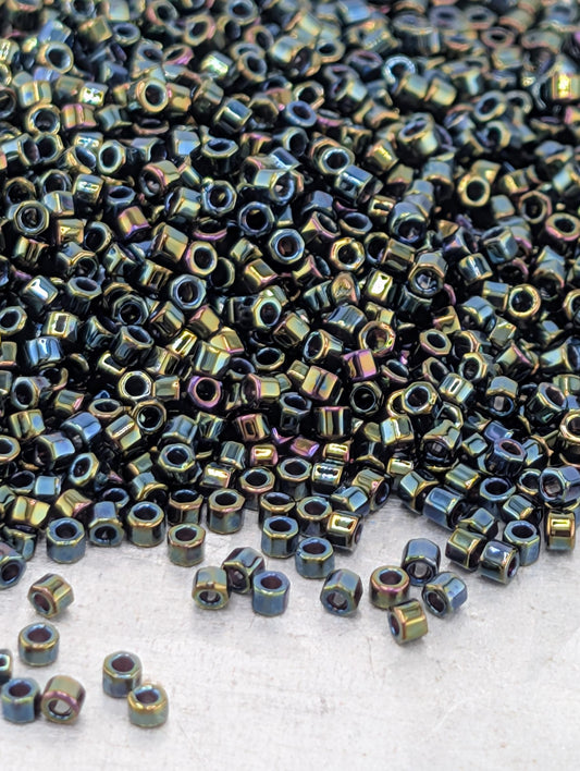 a large pile of multicolored metal nuts or bolts scattered on a surface.