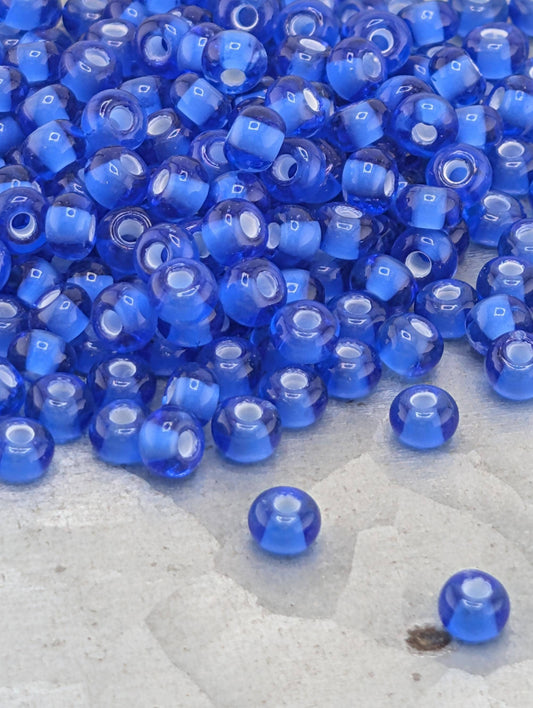 Preciosa Transparent Chalkwhite-Lined Sapphire, 6/0 Rocaille 15g pkg
