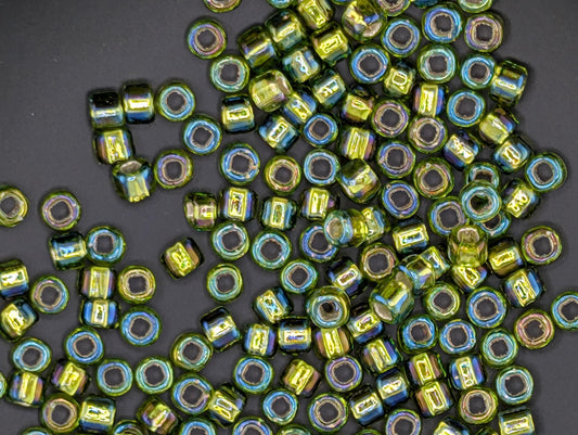 a collection of colorful glass beads scattered on a dark background.