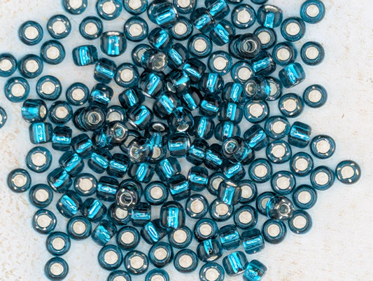 5719SB Transparent Silver Lined Teal Japanese Seed Beads 6/0 (15g Pkg)