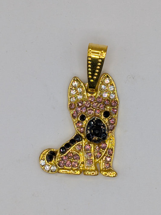 A gold-colored pendant or charm in the shape of a cat, adorned with colorful gemstones or crystals.