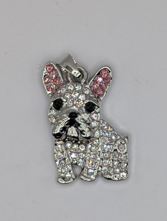 A silver-colored charm in the shape of a dog, adorned with numerous sparkling rhinestones or crystals.