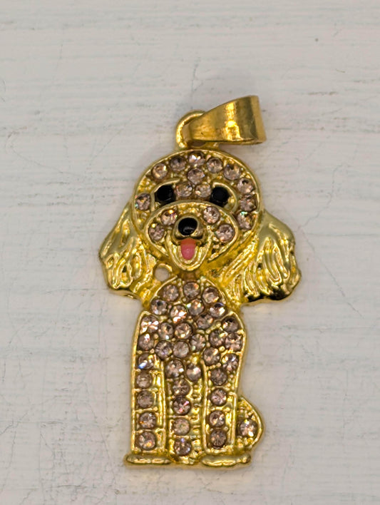 A gold-colored pendant in the shape of a dog, adorned with numerous small diamonds.