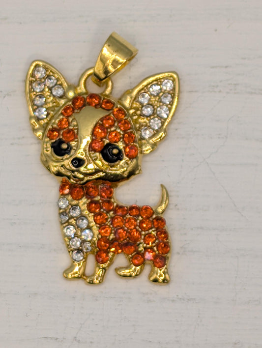 A gold-colored pendant in the shape of a dog, adorned with numerous small orange and white gemstones.