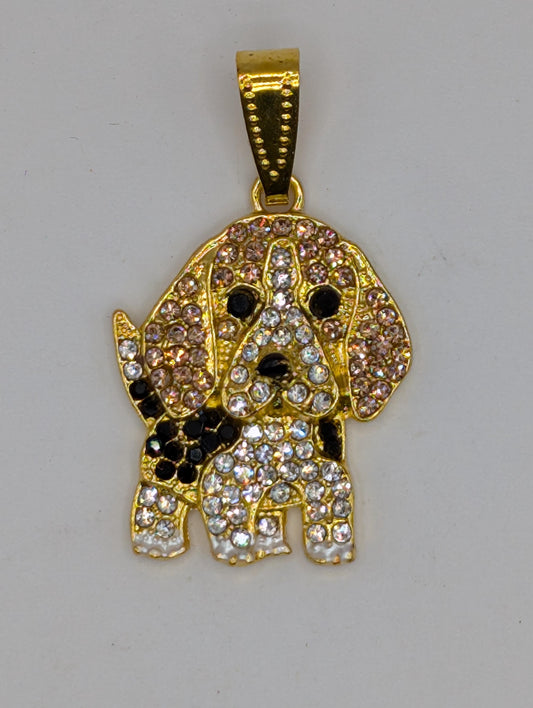 A gold-colored pendant in the shape of a dog, adorned with numerous sparkling diamonds.