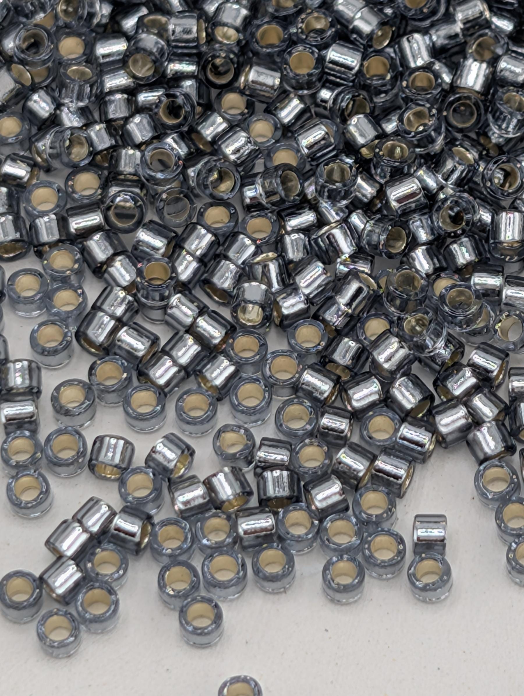 numerous small, silver-colored beads or metal pieces scattered across a surface.