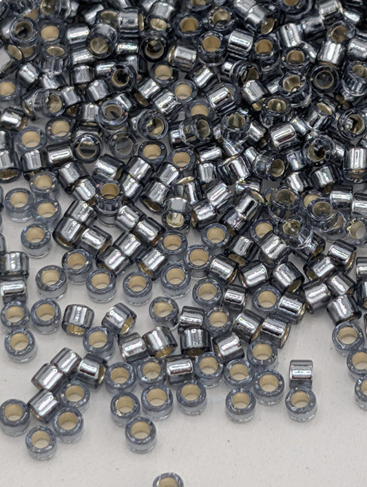 numerous small, silver-colored beads or metal pieces scattered across a surface.